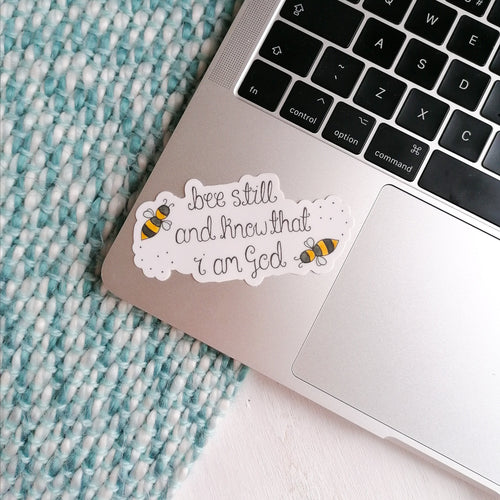 bumble bee christian sticker with the words be still and know that I am god with bees flying around the bible verse
