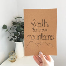 Load image into Gallery viewer, A stunning notebook with hand drawn design of  mountains with the words, &#39;faith can move mountains.&#39; The perfect notebook to fill with journal entries, prayer and sermon notes