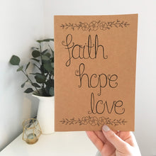 Load image into Gallery viewer, This pretty journal with the words, &#39;faith, hope, love&#39; lettered with a stunning floral design would be the perfect design to gift a loved one for their birthday or as a just because.