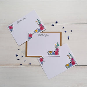 set of floral thank you notecards, with the words thank you lettered across the top of the notecard and a vibrant floral design in the corners, leaving space in the middle for your own message of thanks to a friend