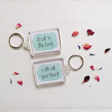 Load image into Gallery viewer, trust in the lord with all your heart bible verse keyring lettered on a blue watercolour background