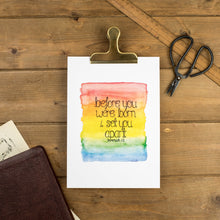 Load image into Gallery viewer, A lovely art print with the words from Jeremiah 1:5, &#39;before you were born I set you apart&#39; lettered onto a rainbow watercolour background. A lovely print to place in a childs bedroom or gift a family.