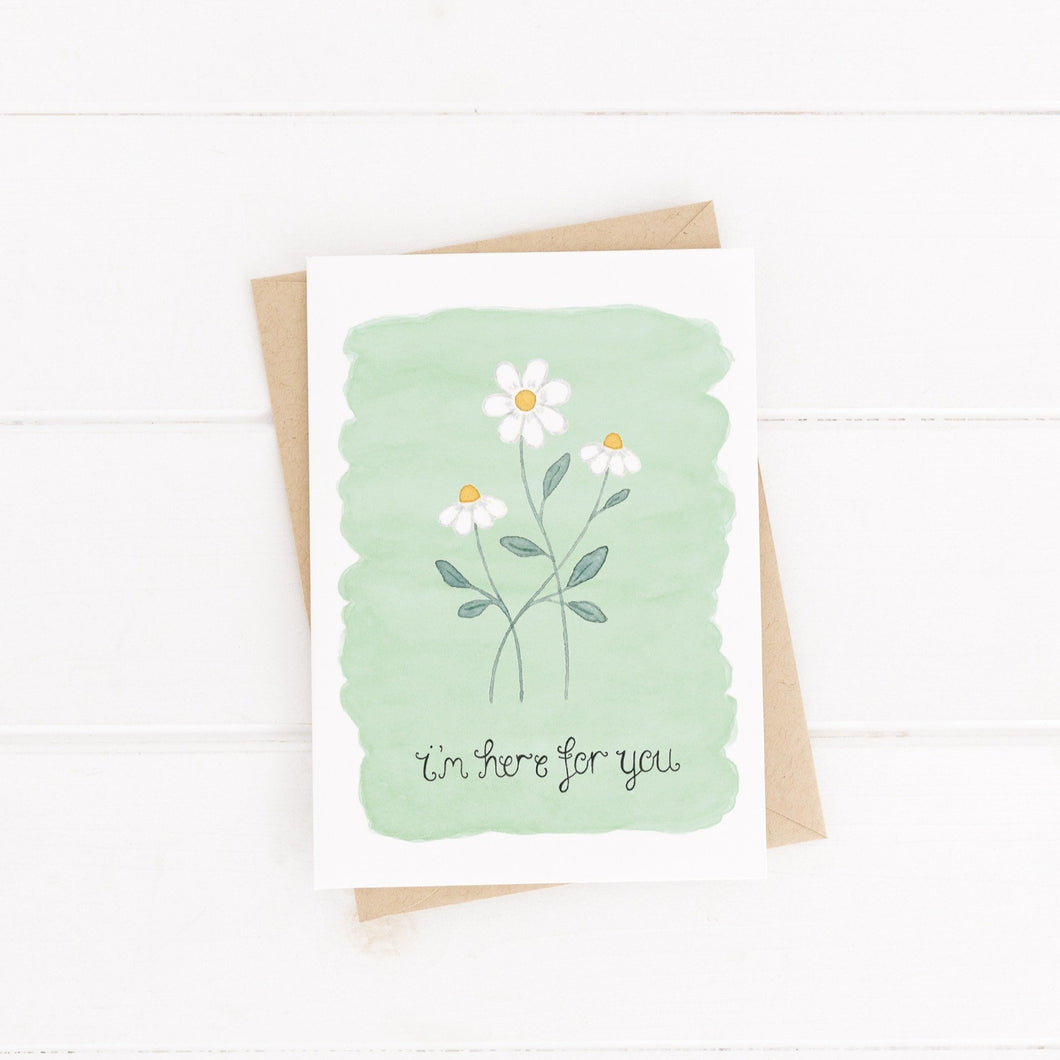 sympathy card with the words i'm here for you hand lettered on the card with a green background and a set of 3 daisies on the front