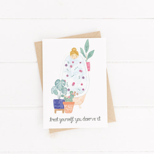 birthday card with an illustration of a girl in a bath with flower petals and plants with the words treat yourself, you deserve it hand lettered on the design, the perfect birthday card for a friend