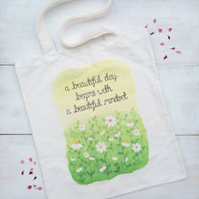 Load image into Gallery viewer, A pretty tote bag with the words, a beautiful day begins with a beautiful mindset, lettered above an illustration of daisies in a meadow.