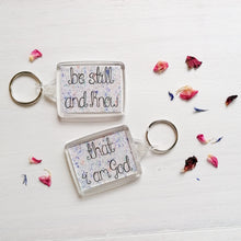 Load image into Gallery viewer, be still and know that i am god bible verse keychain with a pastel splatter pattern behind the words
