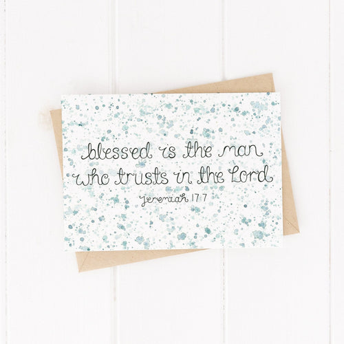 An encouraging Bible verse card with the words, 'Blessed is the man who trusts in the Lord - Jeremiah 17:7' lettered at the centre of the card with a green watercolour splatter design. The perfect card to encourage Christian men.