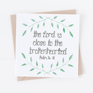 A Christian sympathy card with the words from Psalm 34:18, 'The Lord is close to the brokenhearted' with a dainty leaf pattern surrounding the Bible verse.