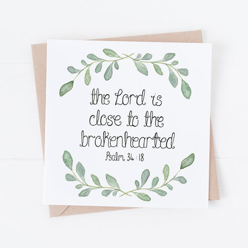 A gentle card with the words, 'the Lord is close to the brokenhearted' from Psalm 34:18 with a simple watercolour leaf wreath design surrounding the words.