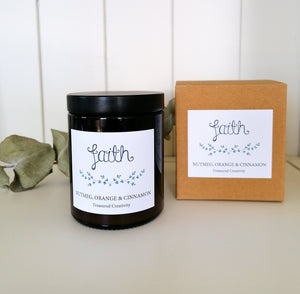 faith candle with nutmeg orange and cinnamon scent in amber jar