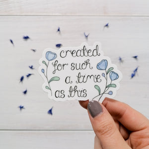 A pretty hand illustrated sticker with the words created for such a time as this hand lettered with delicate blue flowers surrounding