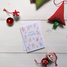 Load image into Gallery viewer, christmas card with the words merry christmas lettered around gingerbread men and women patterned