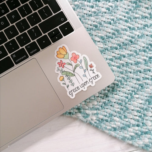 A stunning floral sticker with the words grace upon grace lettered below a pretty floral design