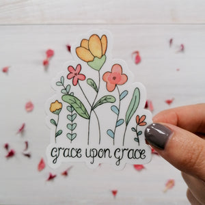 grace upon grace vinyl sticker with a pretty floral bouquet design hand painted about the christian quote