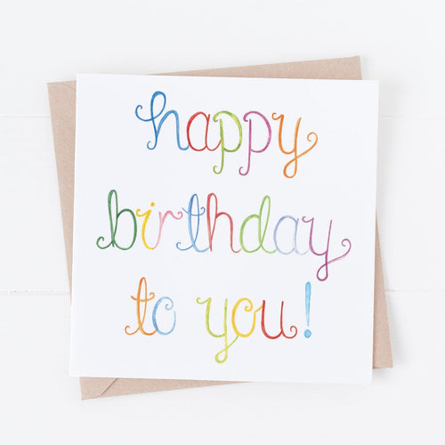 a fun unisex birthday card with the words 'happy birthday to you' hand painted with watercolour, with each letter painted a different colour to create a rainbow effect. A jolly birthday card for a loved one.