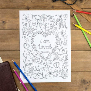 bible verse colouring page with the words I am loved written in the middle of flowers to colour
