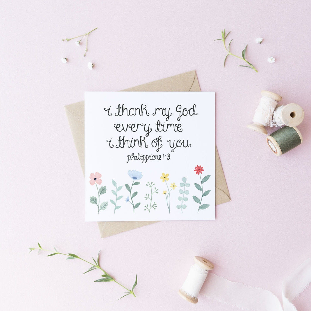 An uplifting greeting card with the words from Philippians 1:3 'I thank my god every time I think of you' with dainty watercolour flowers painted beneath the verse.