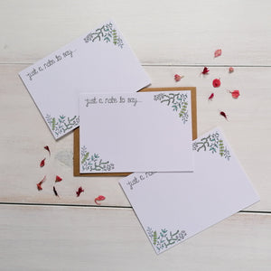 notecard set with the words 'just a note to say' hand lettered on the design alongside a leaf pattern to fill with words of encouragement and love. A set of 10 notecards with kraft envelopes to accompany.