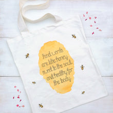 Load image into Gallery viewer, Christian tote bag with the words Kind words are like honey, sweet to the soul and healthy for the body, from proverbs 16:24, lettered at the centre with honey and bumble bees surrounding.