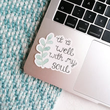 Load image into Gallery viewer, sticker with the words, it is well with my soul with a leaf design placed on a laptop