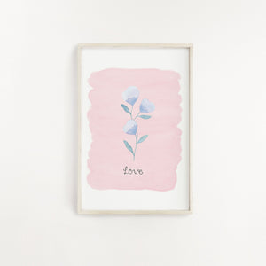 A striking wall print of a purple flower with the word Love lettered beneath and a complimentary pale pink background. A sweet addition to add to your home.