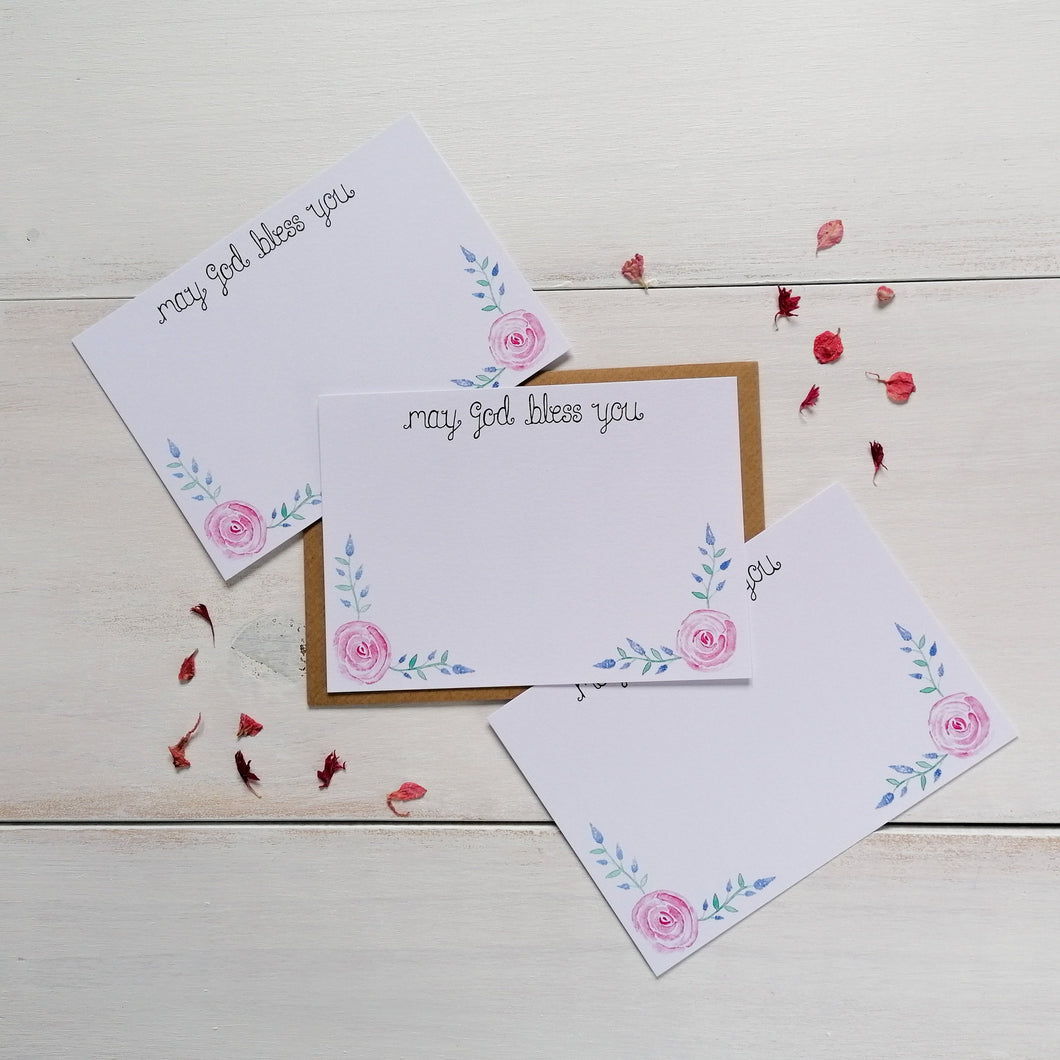 set of 10 christian notecards with the words 'may god bless you' at the top of the card and with a pink and purple floral design painted at the bottom with space to write messages to family and friends