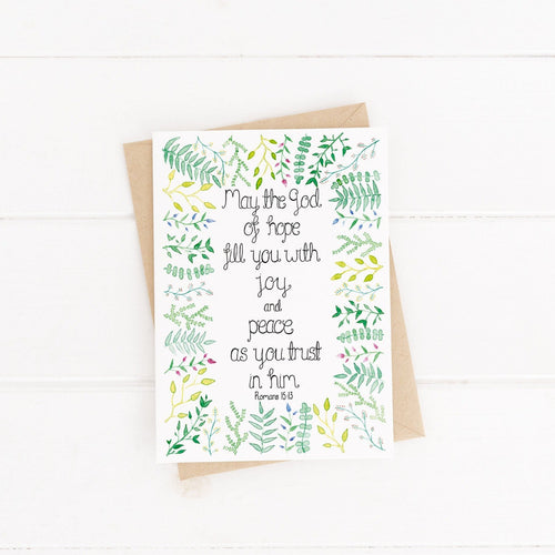 A leafy design Bible Verse encouragement card with words from Romans 15:13, 'may the God of hope fill you with joy and peace as you trust in Him.' A variety of hand painted watercolour leaves surround the uplifting verse.