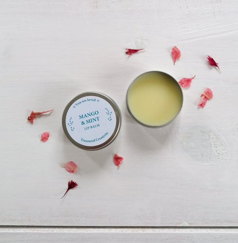 mango and mint organic lip balm with the words you are loved written on the design