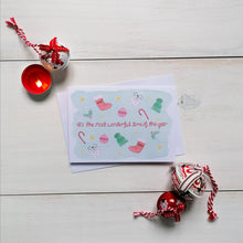 Load image into Gallery viewer, festive christmas card with holly, candy canes, wooly hats and other festive illustrations surrounding the words, it&#39;s the most wonderful time of the year