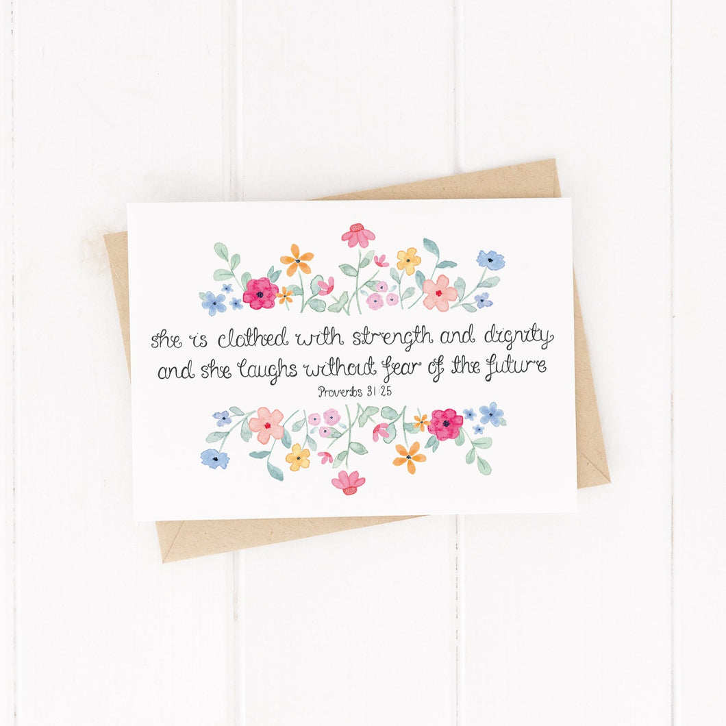A vibrant floral Bible verse card with the words from Proverbs 31:25, 'she is clothed with strength and dignity and she laughs without fear of the future.' A stunning card to fill with kind words and encourage the girls in your life.
