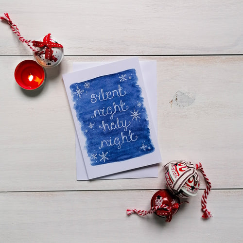Silent night holy night christmas carol christmas card with snowflake design surrounding the words