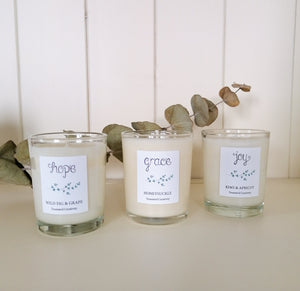 set of 3 soy candles, with scents including wild fig & grape, honeysuckle, and kiwi & apricot