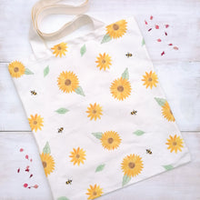 Load image into Gallery viewer, The back side of a christian proverbs 16:24 tote bag with a sunflower and bumble bee pattern, printed on bleached 10oz canvas.