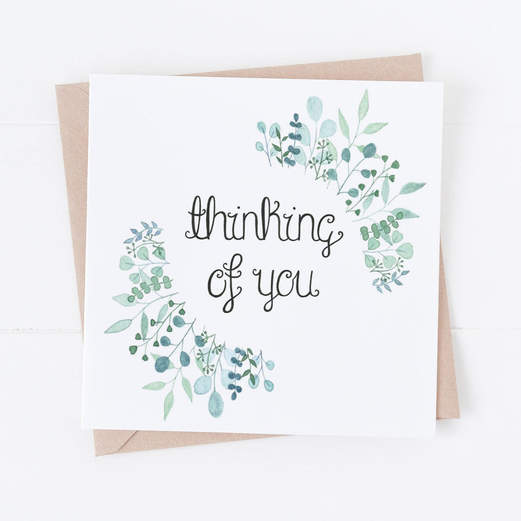 A hand illustrated greeting card with the words 'thinking of you' lettered at the centre of a stunning watercolour leaf design. A thoughtful card to send to a loved one when they are experiencing a difficult season or as an encouragement.