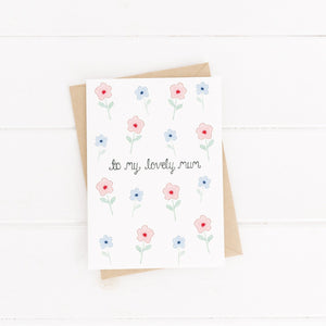 A pink and blue floral pattern greeting card with the words to my lovely mum hand lettered on the front. An uplifting card to fill with words of love and gratitude this Mother's Day.