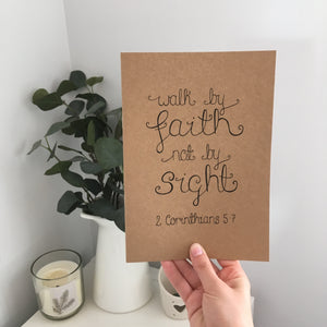 A stunning kraft journal with the words, 'walk by faith not by sight' lettered on the front. A lovely notebook to use for journaling or gift a loved one with.