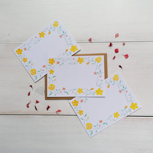 set of yellow flower patterned notecards with the floral design painted around the card and with a blank space in the middle to write your message for loved ones