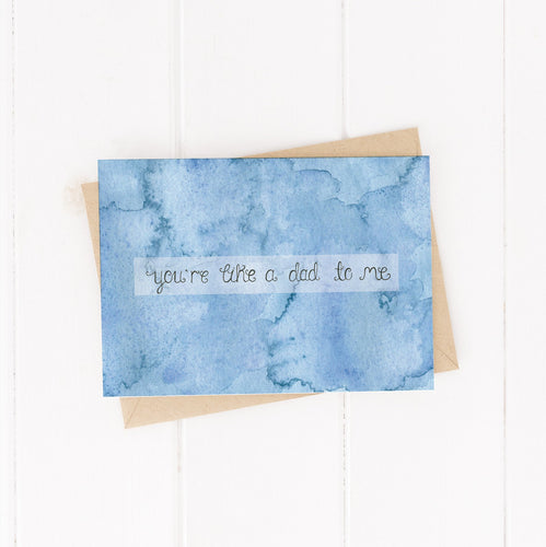 An abstract blue watercolour greetings card with the words you're like a dad to me hand lettered through the centre of the design, alternative card for father's day, perfect for step dad